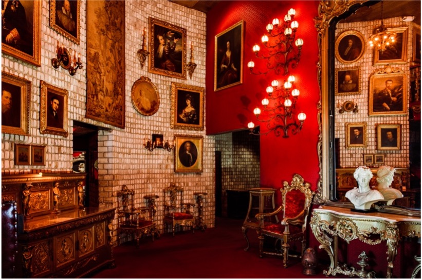 Berns entryway featuring red and white brick walls, framed artwork, and luxury décor.