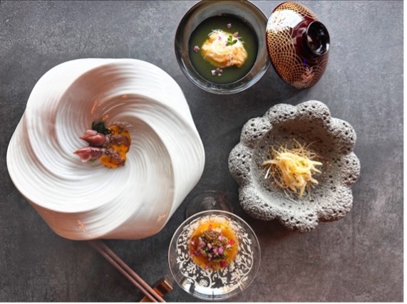 Gourmet food bowls displayed on a stone countertop, showcasing the fine dining experience at Kosen. 