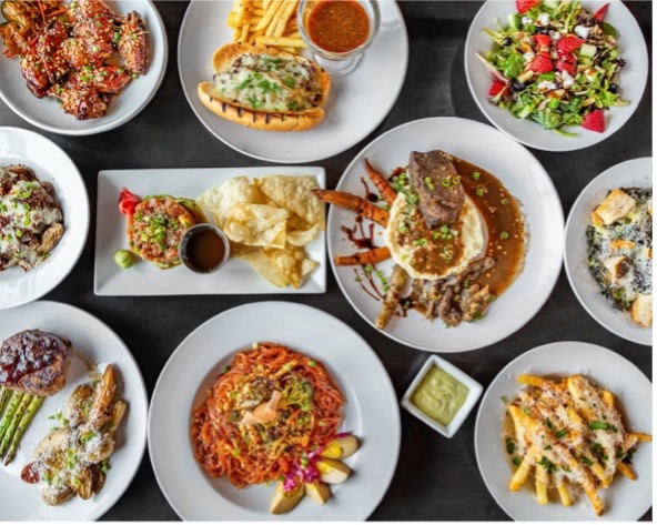 Variety of colorful fine dining dishes arranged on white plates, showcasing the fine dining experience at Rome & Fig.